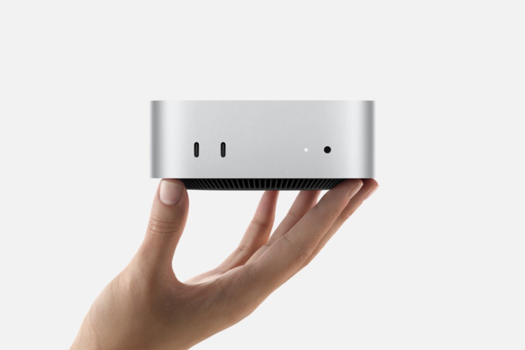Mac mini M4 held in hand